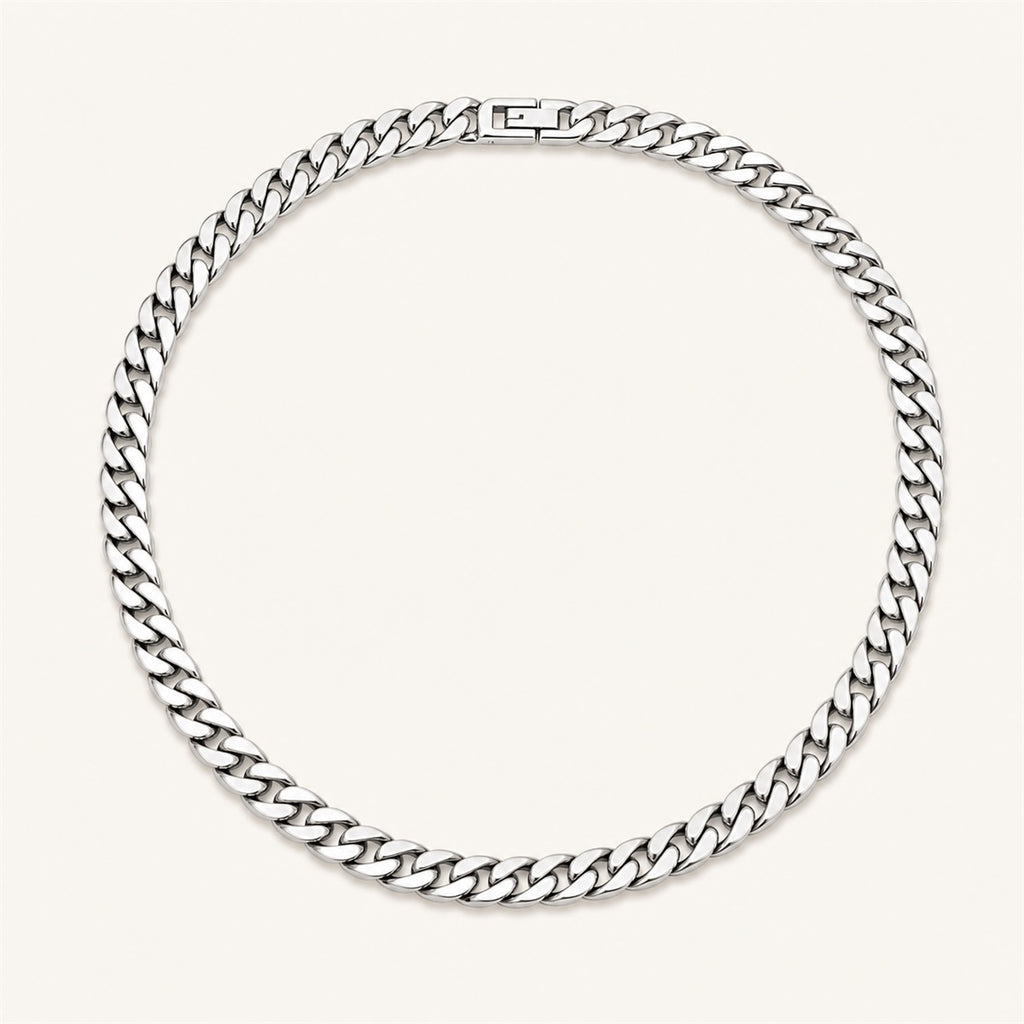 Silver Cuban link chain necklace on a warm white background