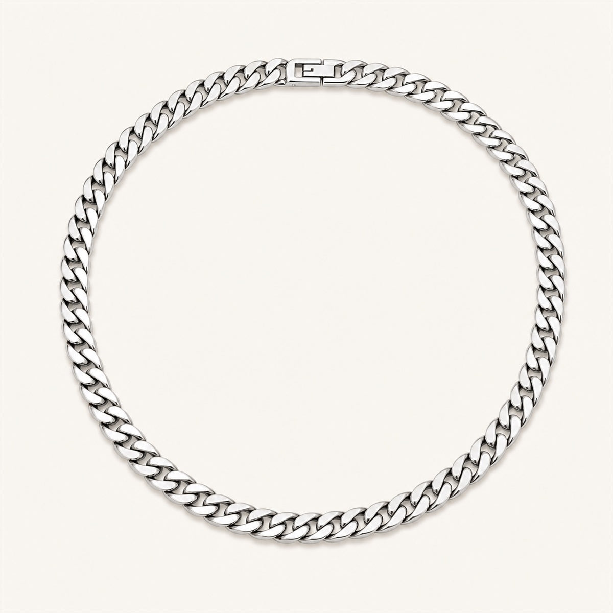 Silver Cuban link chain necklace on a warm white background