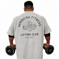 Mens heather grey oversized lifting club tee with bold back dumbbell graphic