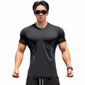 Core Black: Mens black contour compression training tee with short sleeves and side line graphics