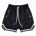 Core Black: Mens black mesh training shorts with zip pockets, white drawcord, and striped hem