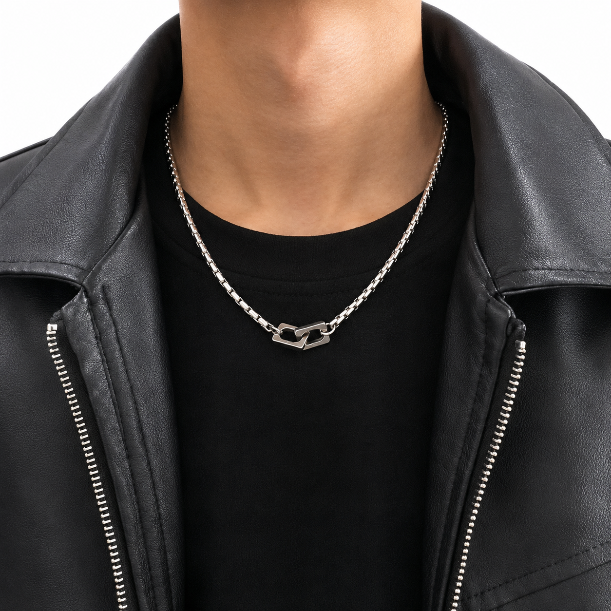 Silver-tone double heart pendant necklace worn with black shirt and leather jacket