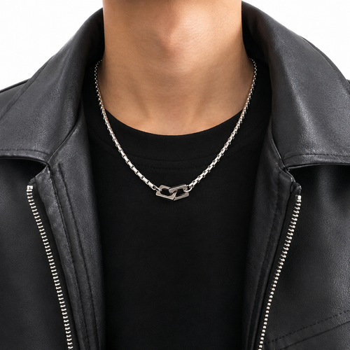 Silver-tone double heart pendant necklace worn with black shirt and leather jacket