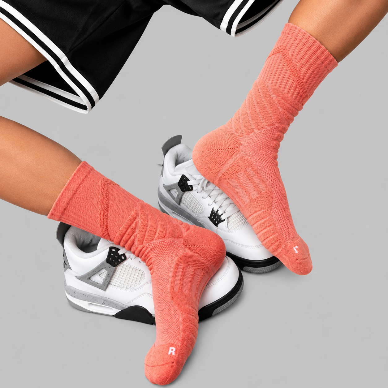 Coral men's performance crew socks styled with white sneakers