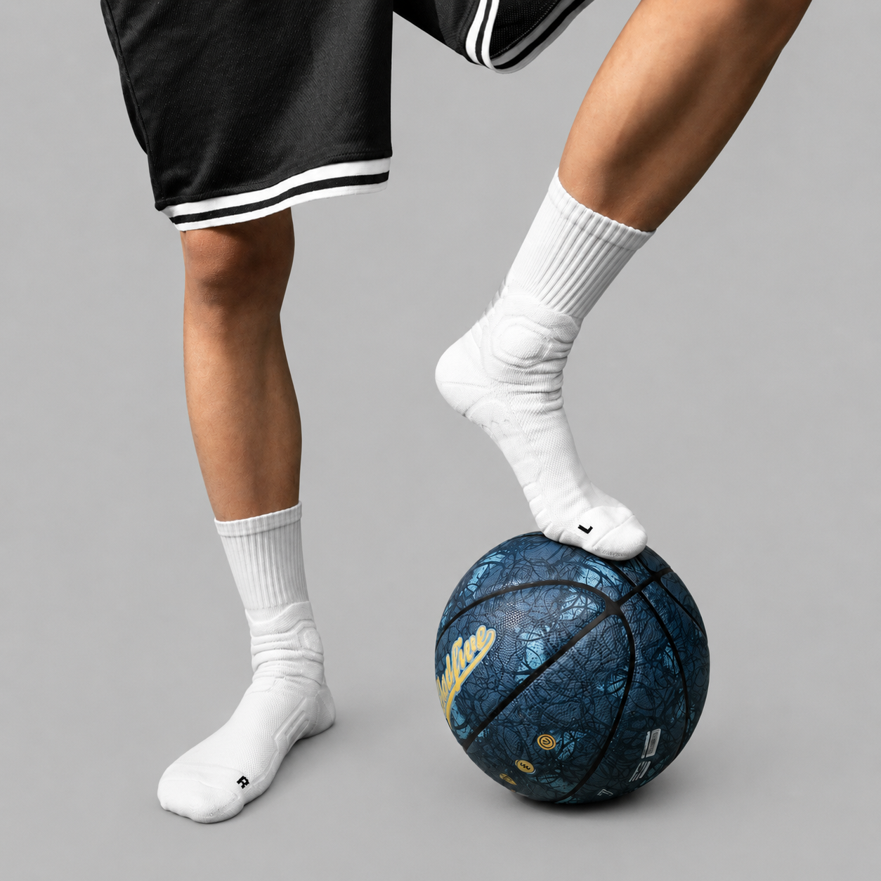 White men's cushioned crew socks worn with basketball shoes and shorts