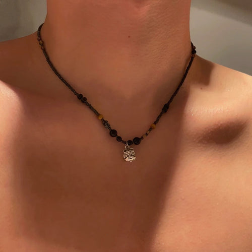 VAREN FORM Lion Bead Pendant Necklace model wearing black beaded lion pendant necklace