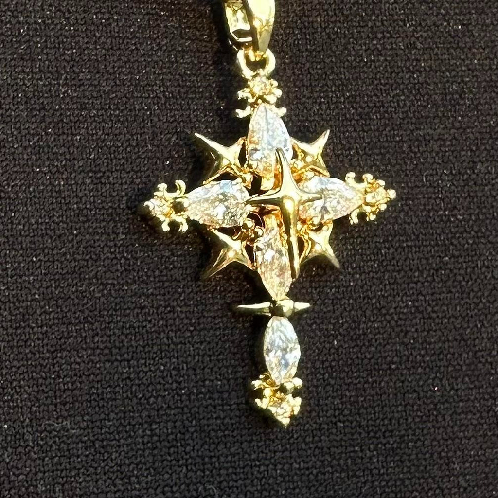 Close-up of the gold-tone cross pendant and linked chain