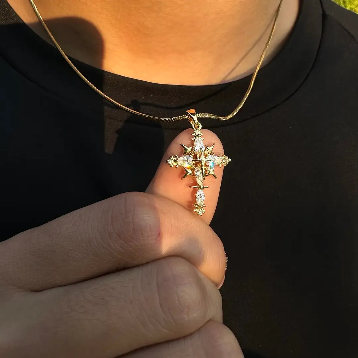 Gold-tone ornate cross pendant necklace shown worn with a black shirt