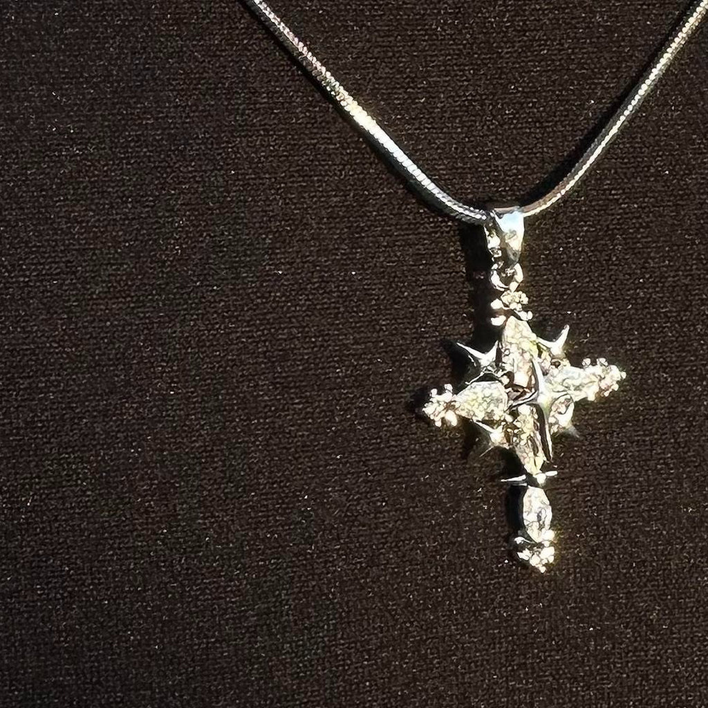Close-up of the silver-tone cross pendant necklace