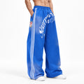 Men's Letter-Print Side-Stripe Wide-Leg Track Pants in blue - worn view