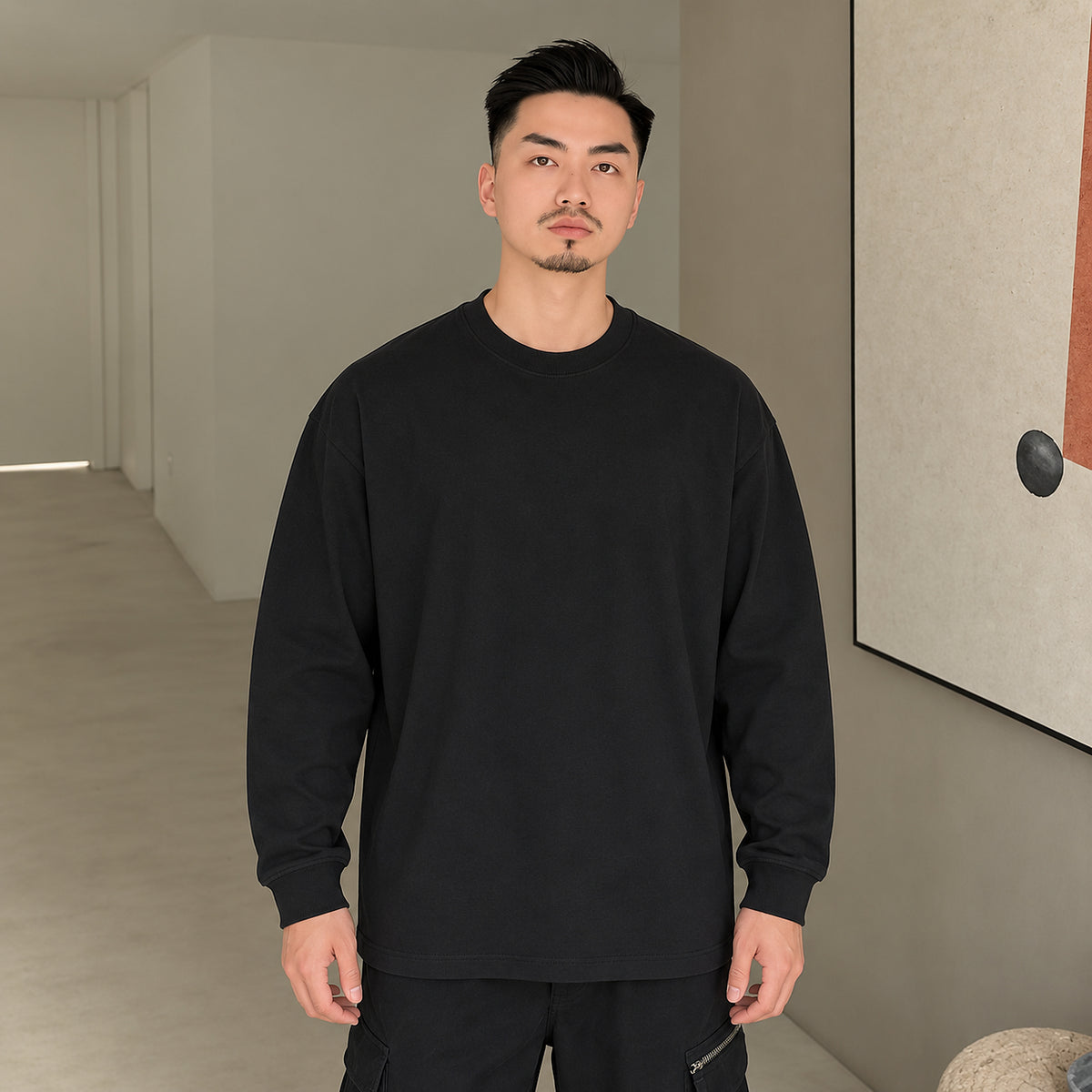 Men's black 400 GSM heavyweight cotton long-sleeve crewneck T-shirt, front outfit view
